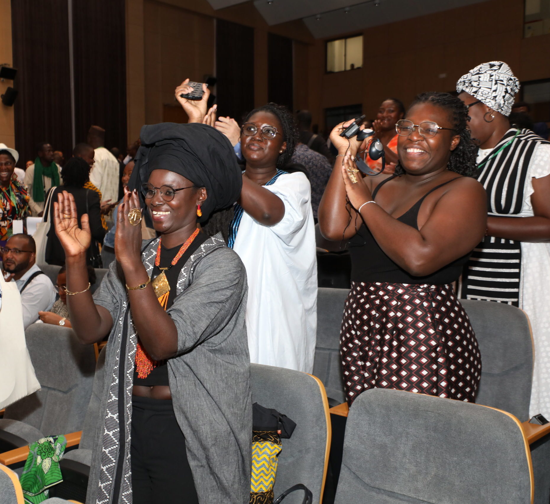 Women clapping hands in a seminar hall,